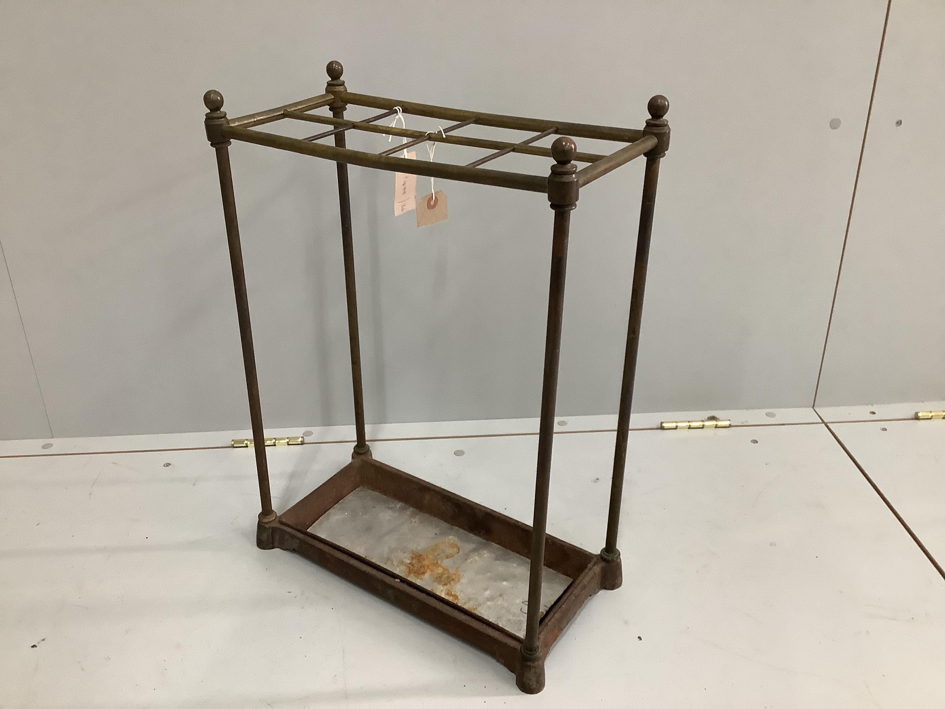 An early 20th century tubular brass and cast iron eight division stick stand, width 42cm, depth 20cm, height 58cm